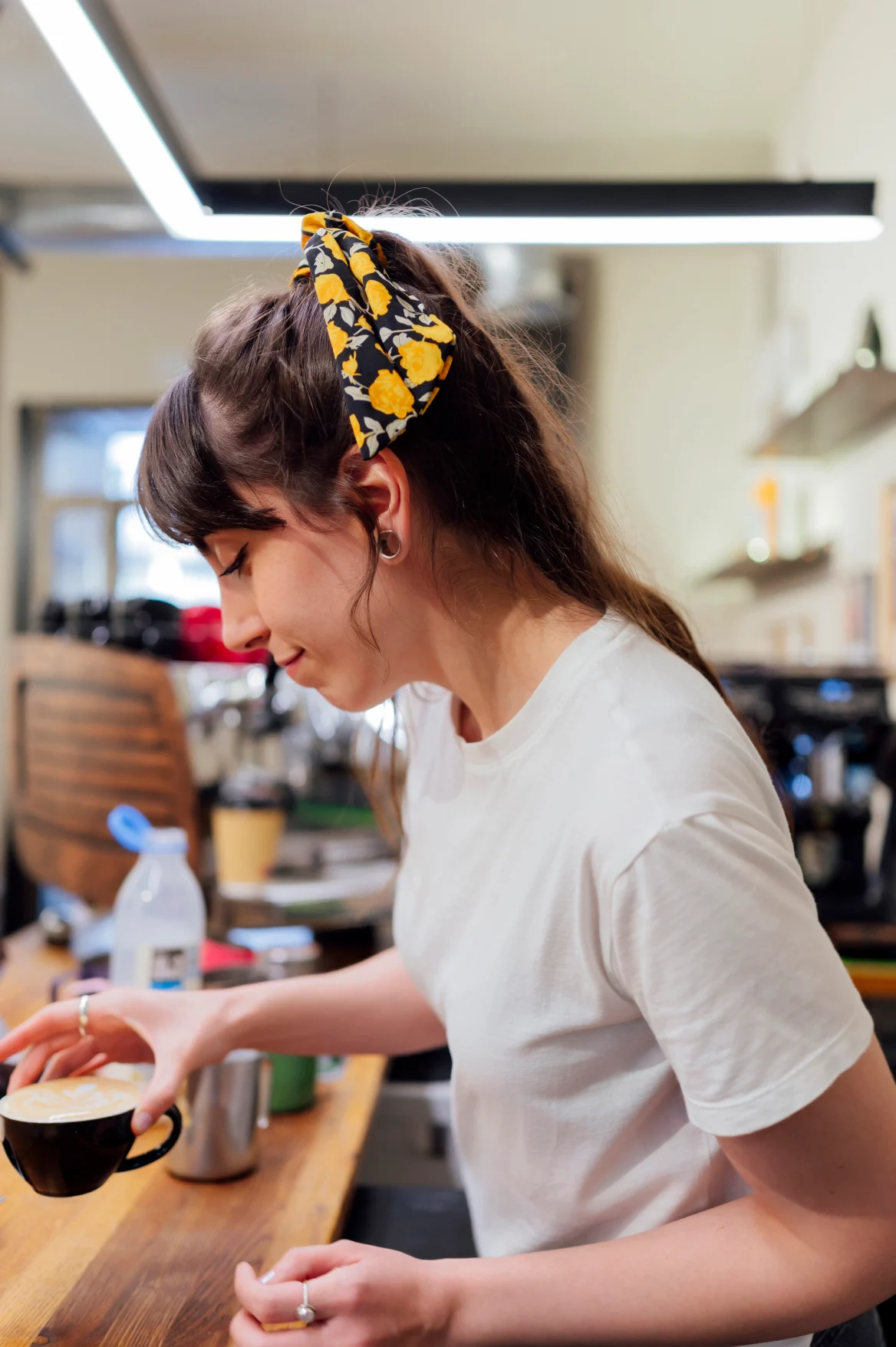 Barista preparing cappuccino in a coffee shop.