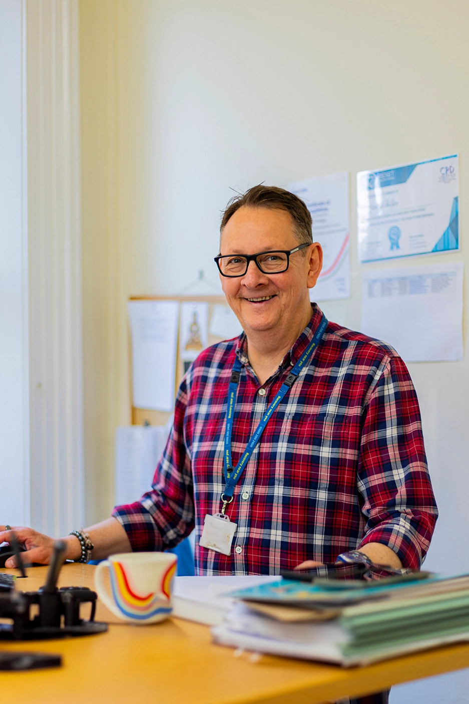 A happy member of Aquarius staff at a desk.