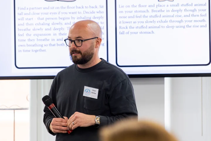 A person delivering a presentation to a group.