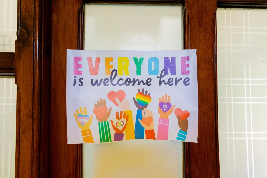 Poster with "everyone is welcome here" written on it.
