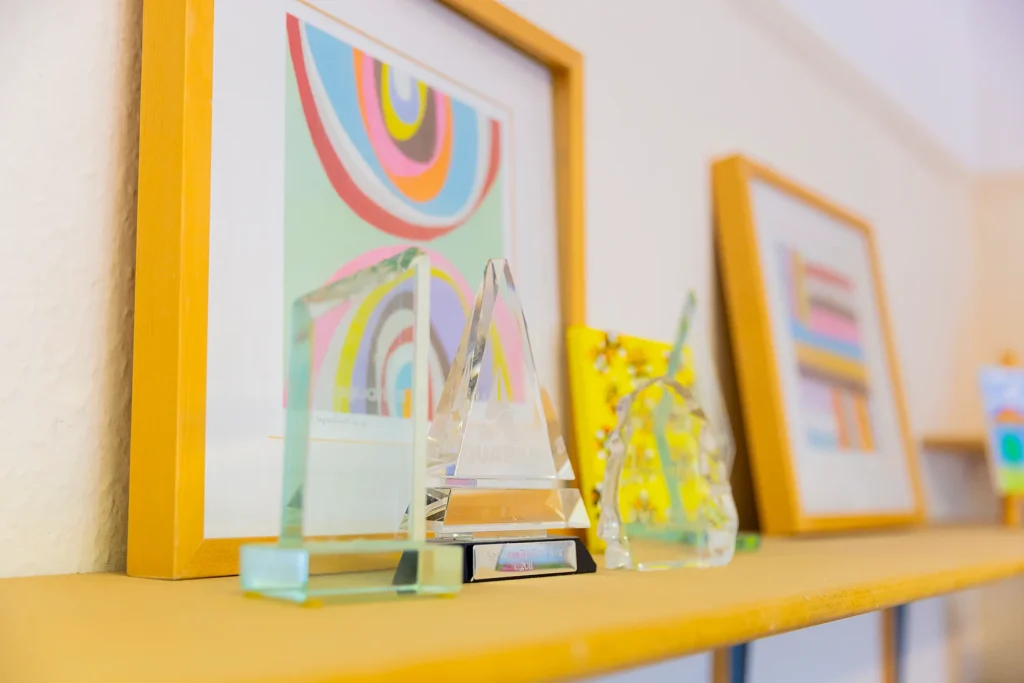 Framed artwork on a shelf.