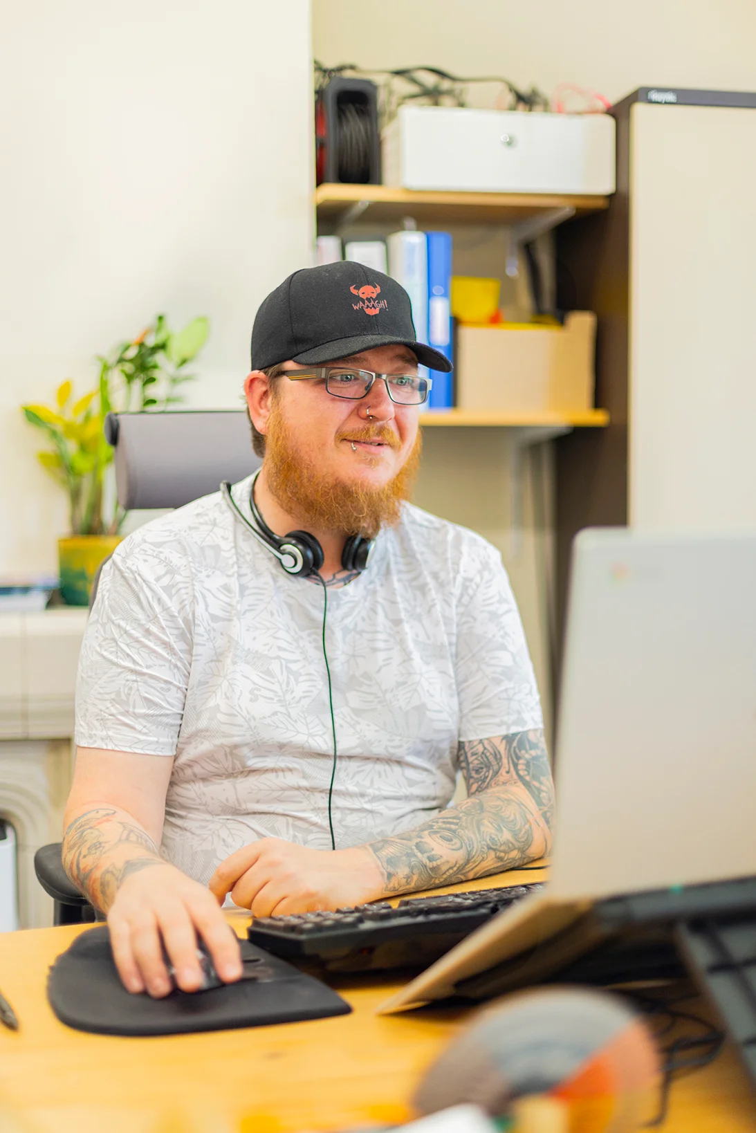 Young person using a laptop at a desk.
