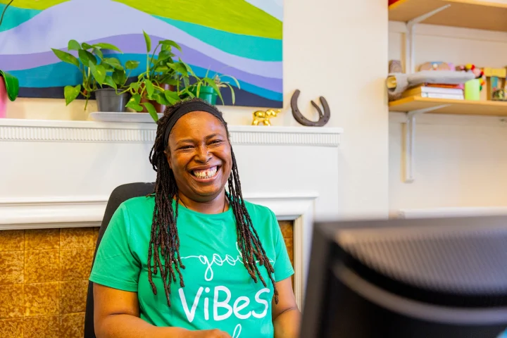 A happy member of Aquarius staff at a desk.